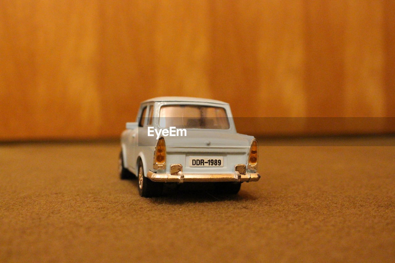 CLOSE-UP OF TOY CAR ON TABLE AT HOME