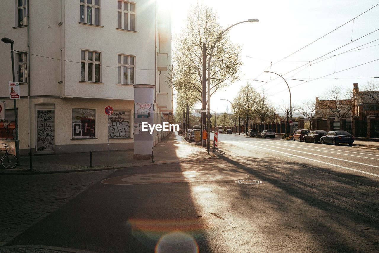 STREET AMIDST BUILDINGS AGAINST SKY