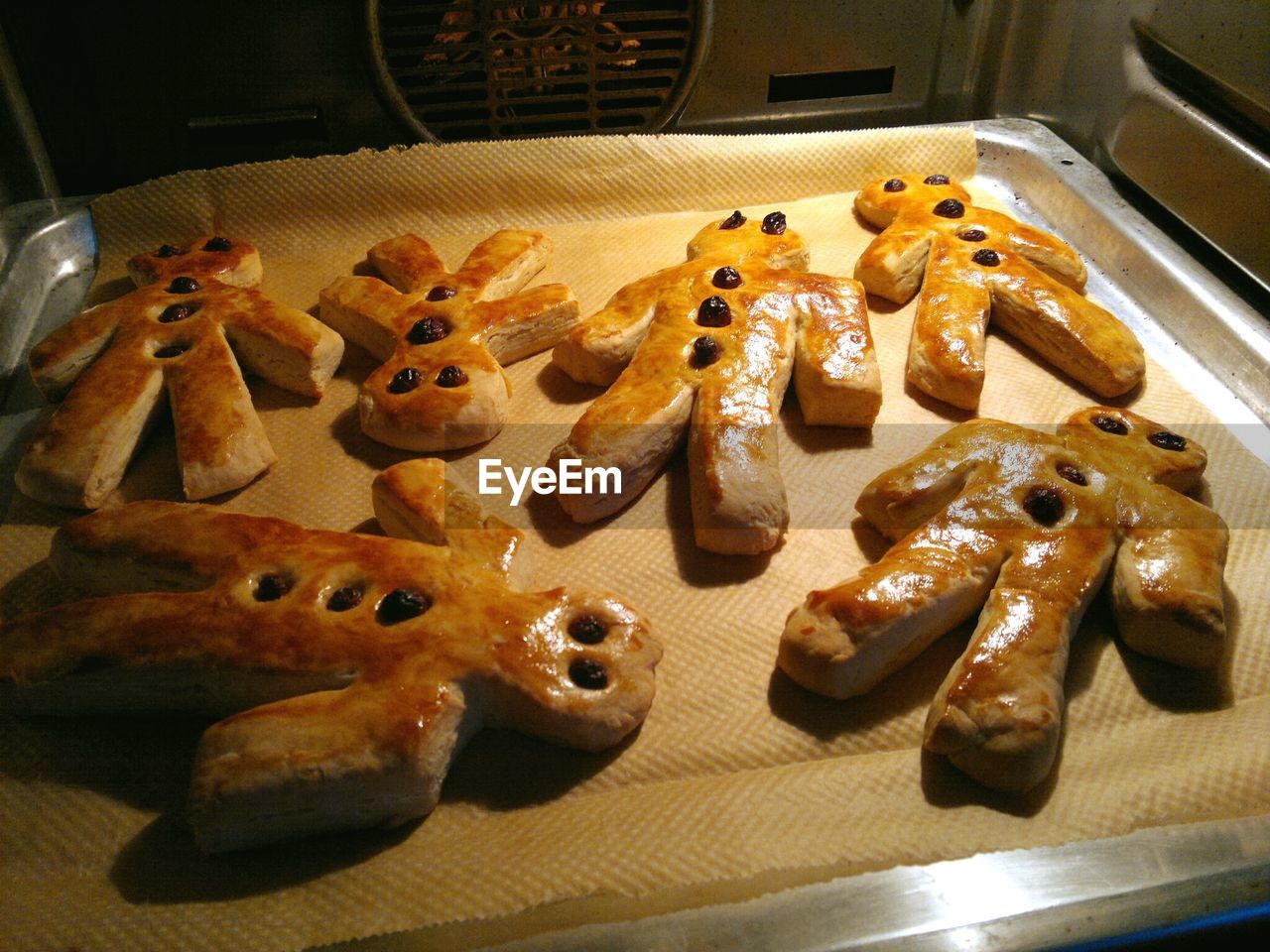 High angle view of human shaped cookies on tray