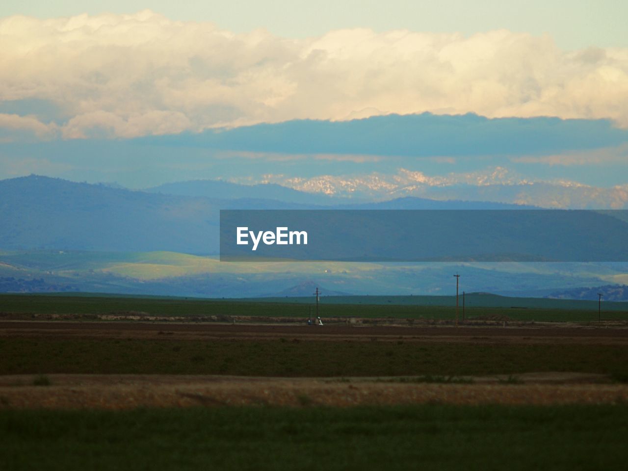 SCENIC VIEW OF MOUNTAINS AGAINST CLOUDY SKY