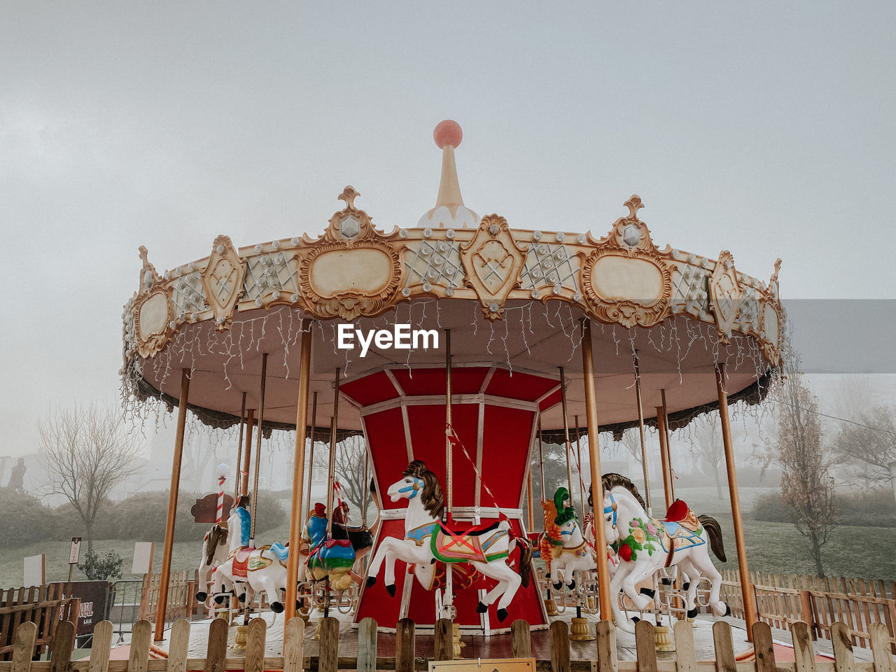 Low angle view of carousel against clear sky