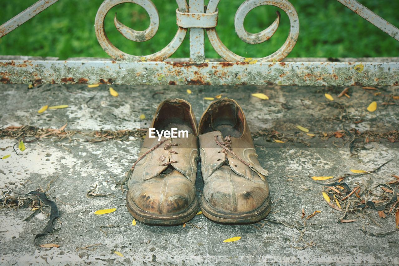 High angle view of shoes on footpath