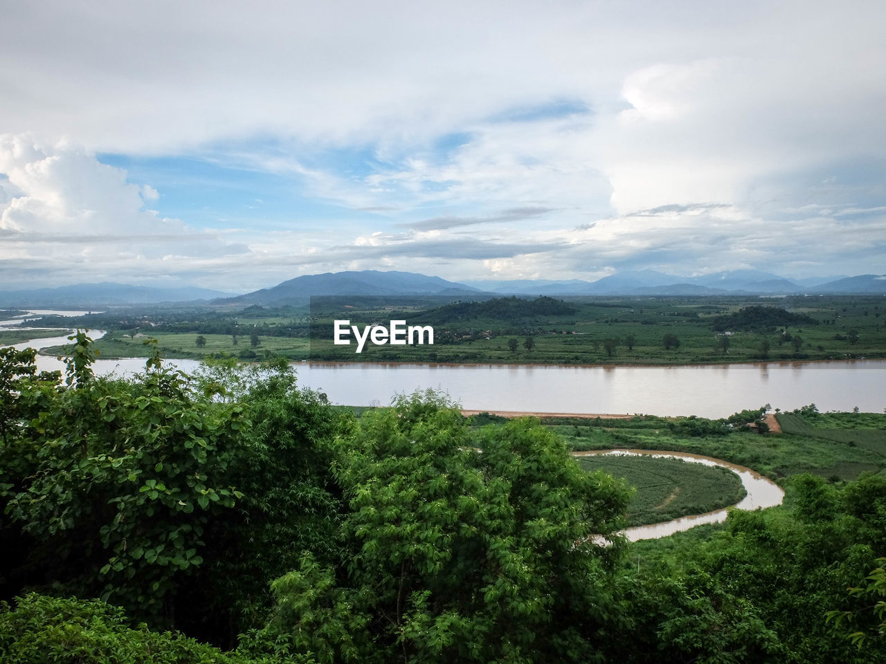 Scenic view of lake against cloudy sky