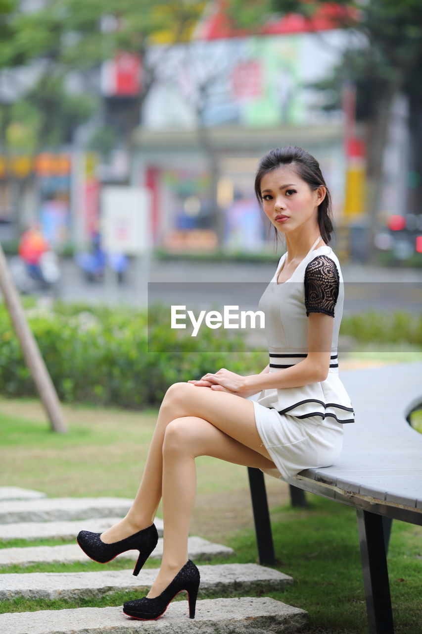 Portrait of young woman sitting outdoors