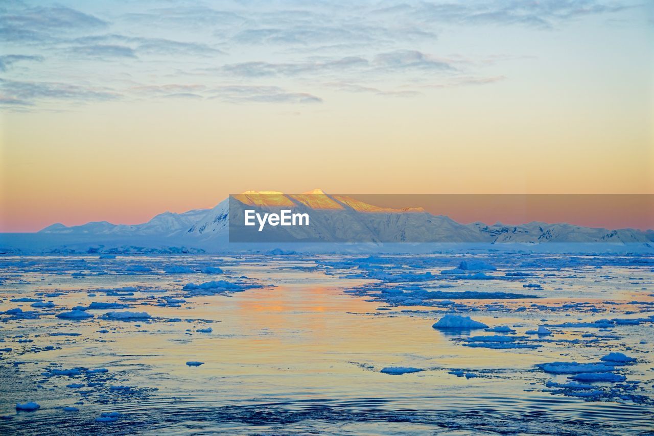 Scenic view of mountains against sky at sunset