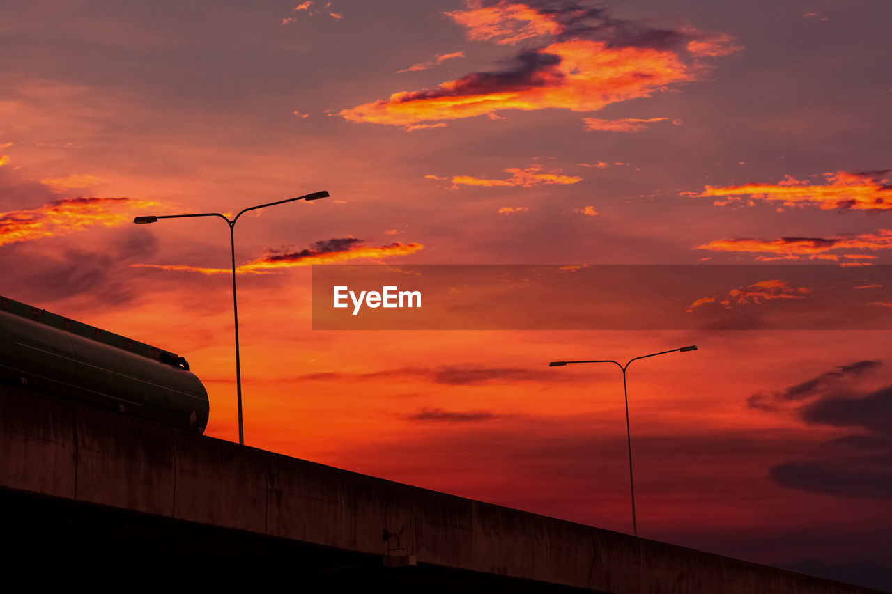Bottom view of elevated concrete highway with sunset sky. overpass concrete road. road flyover.