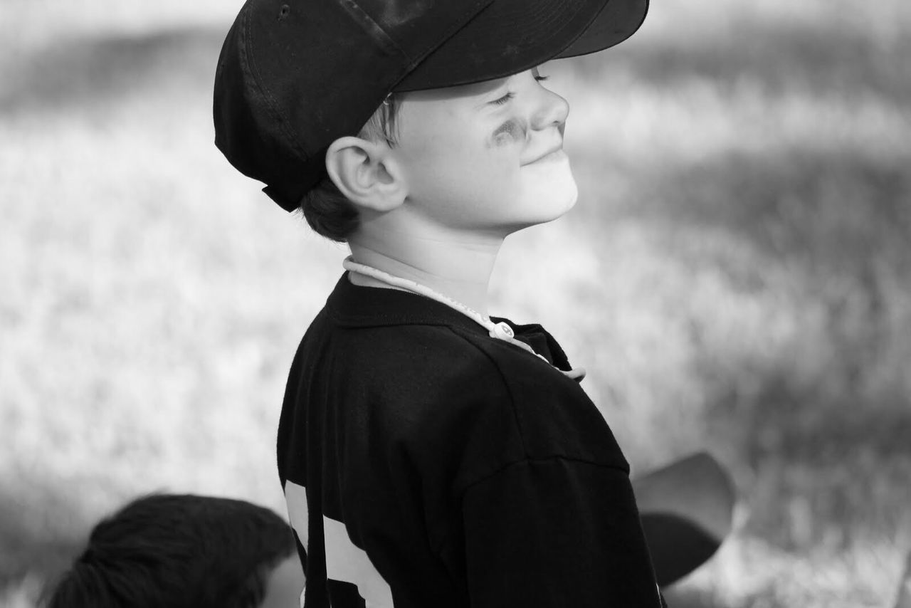 High angle view of boy with closed eyes on field