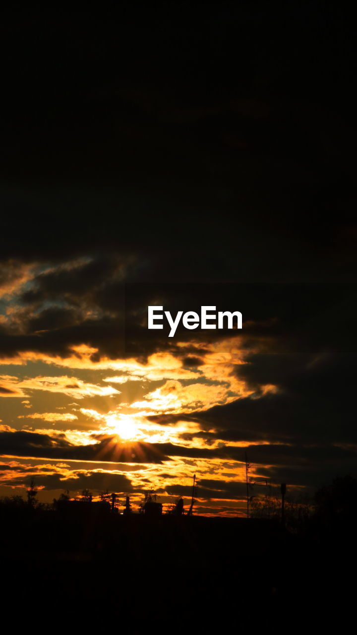 SCENIC VIEW OF SILHOUETTE LANDSCAPE AGAINST DRAMATIC SKY