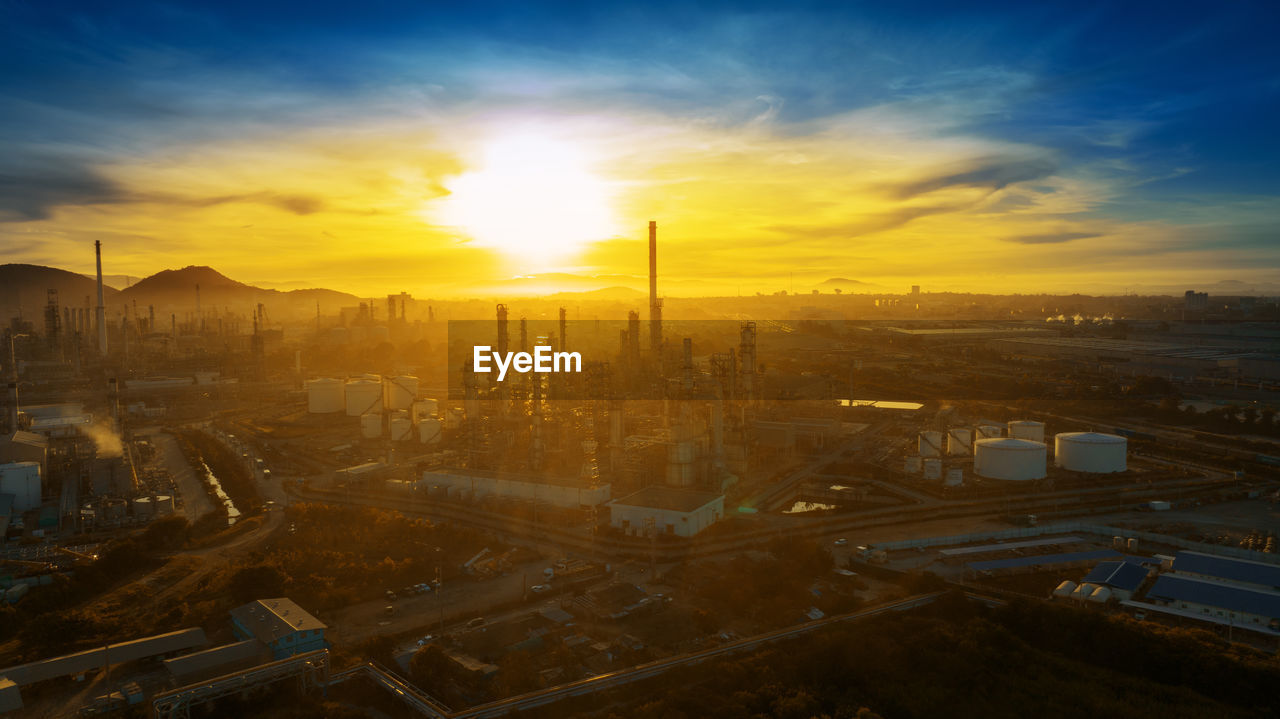 high angle view of illuminated cityscape against sky during sunset