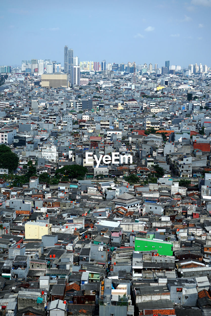 High angle view of city buildings against sky