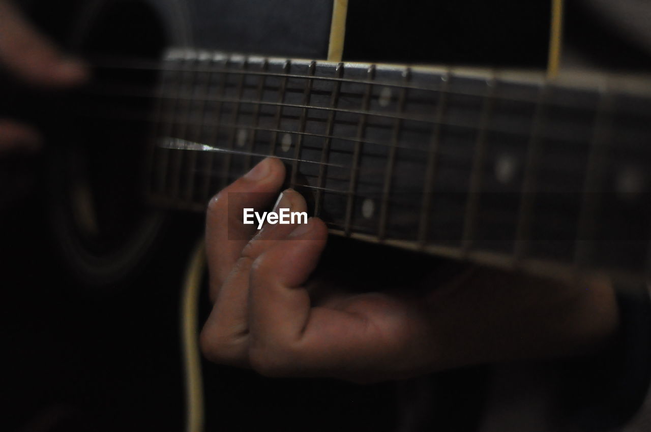 WOMAN PLAYING GUITAR