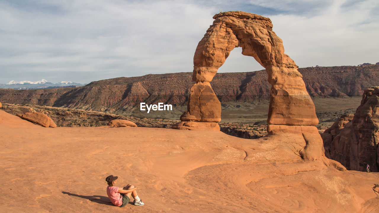 PEOPLE STANDING ON ROCK