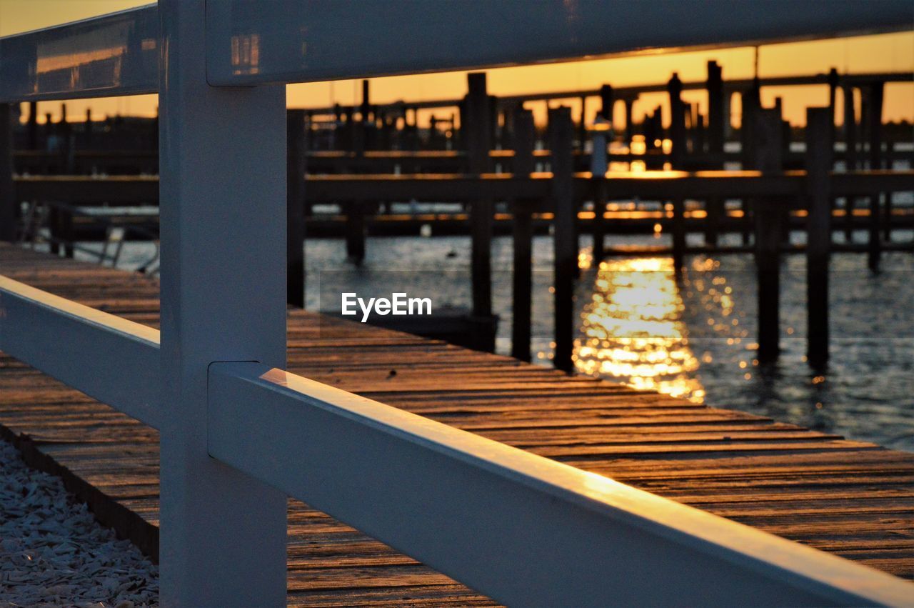 CLOSE-UP OF PIER ON RIVER AGAINST SKY