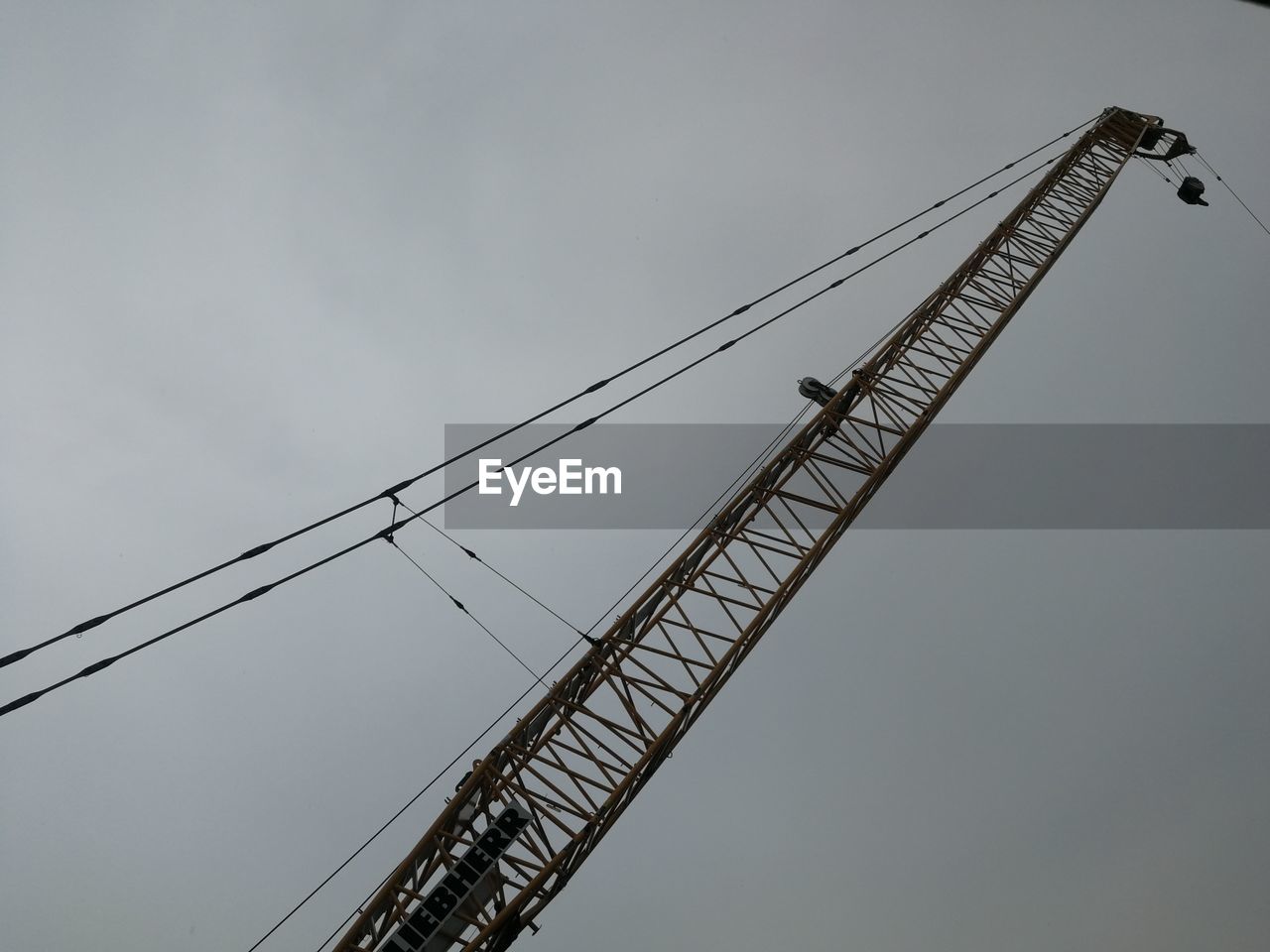 LOW ANGLE VIEW OF CRANE AT CONSTRUCTION SITE