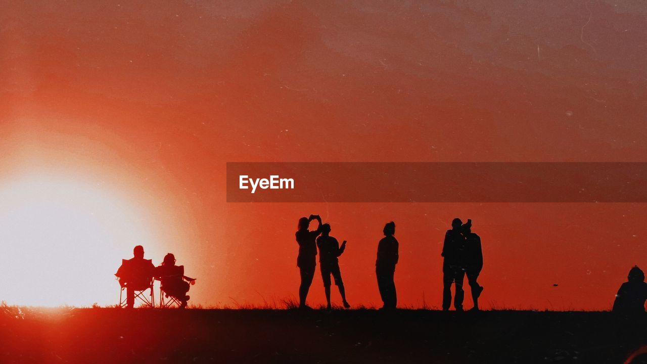 SILHOUETTE PEOPLE WALKING ON SAND AT DESERT
