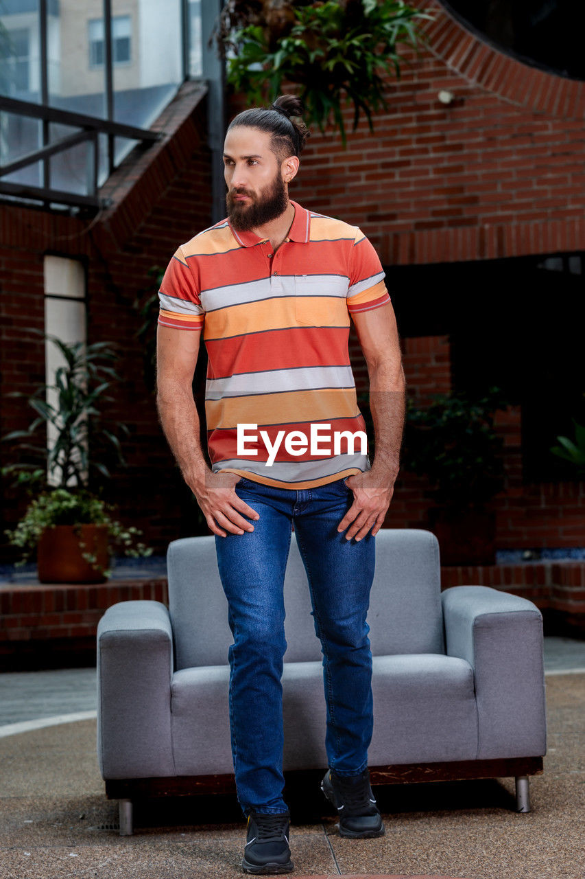 Portrait of man near a sofa