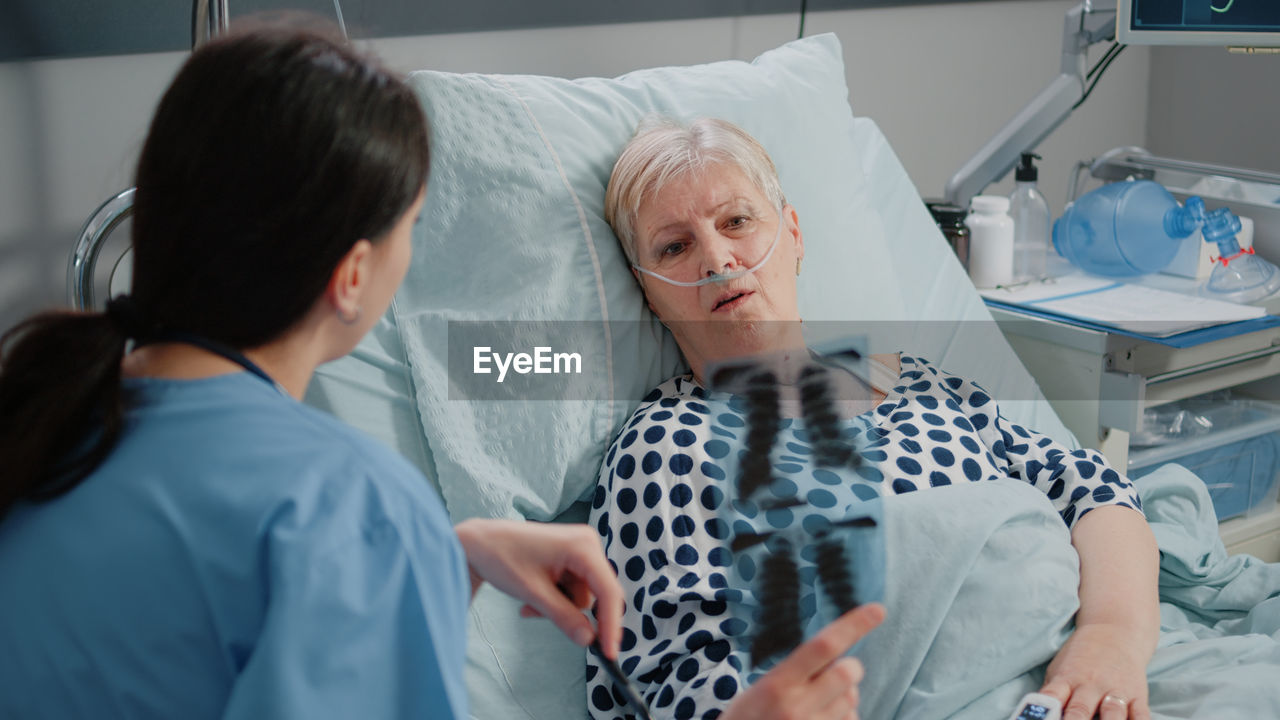 Nurse showing medical xray to patient