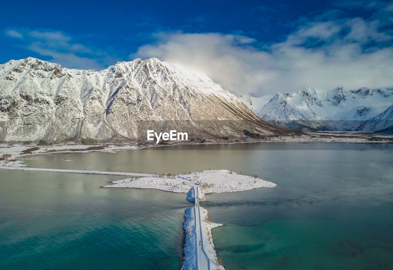 Scenic view of lake and snowcapped mountains against sky