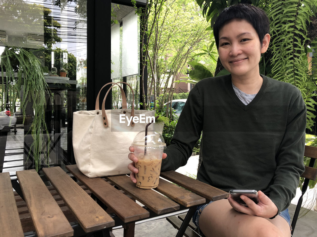 Portrait of smiling woman having coffee at cafe