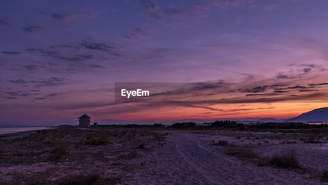 Scenic view of land against sky during sunset