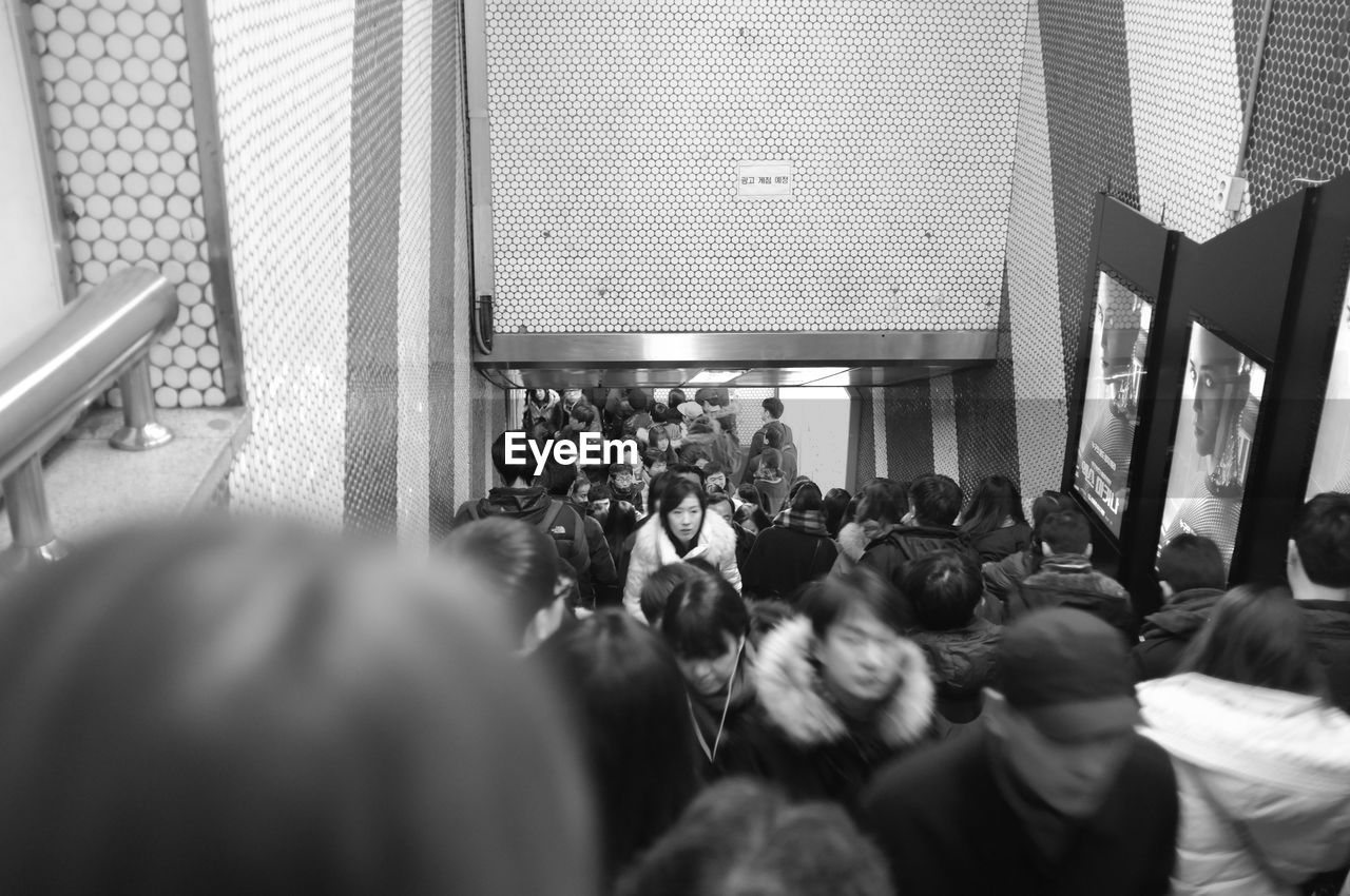 Crowds walking on steps at subway station