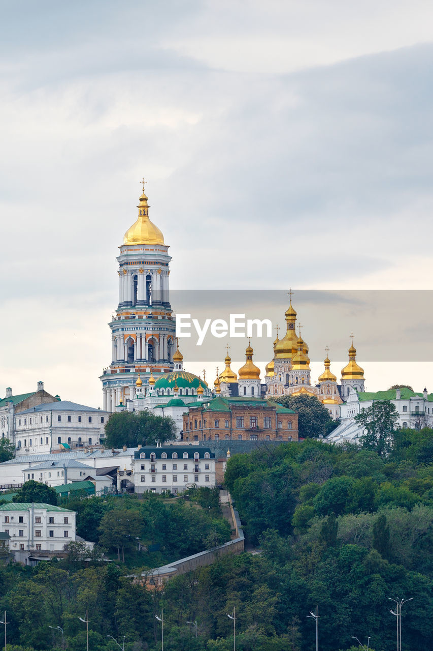 The bell tower of the pechersk lavra and the golden domes of the monastery on the slopes of the kyiv