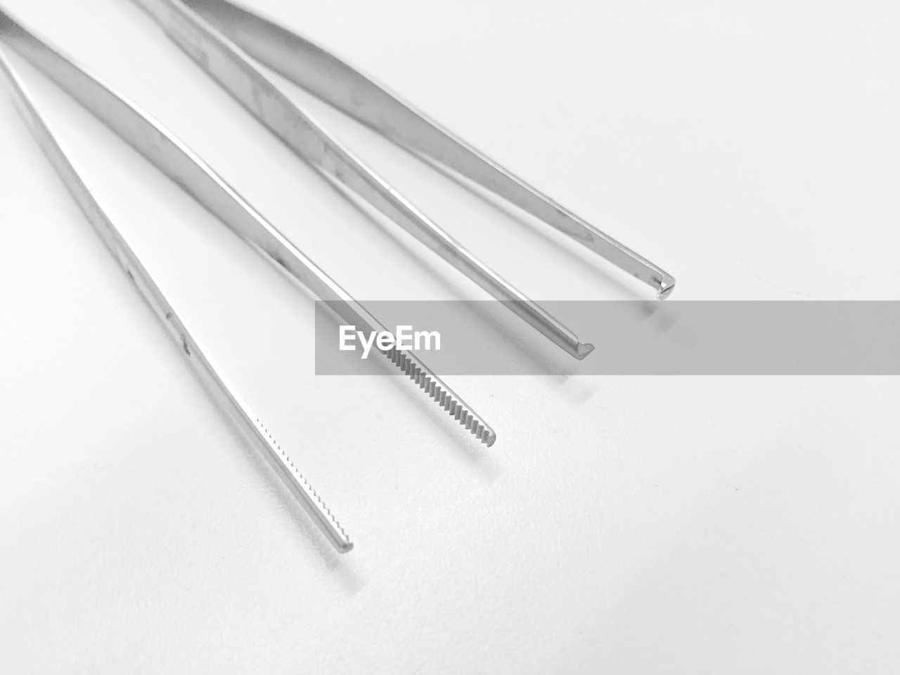 Close-up of tweezers against white background