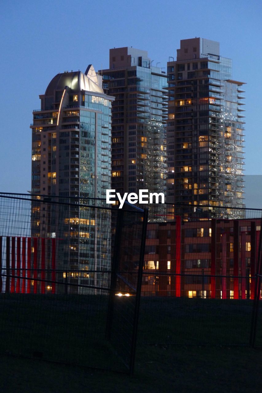 LOW ANGLE VIEW OF ILLUMINATED BUILDINGS