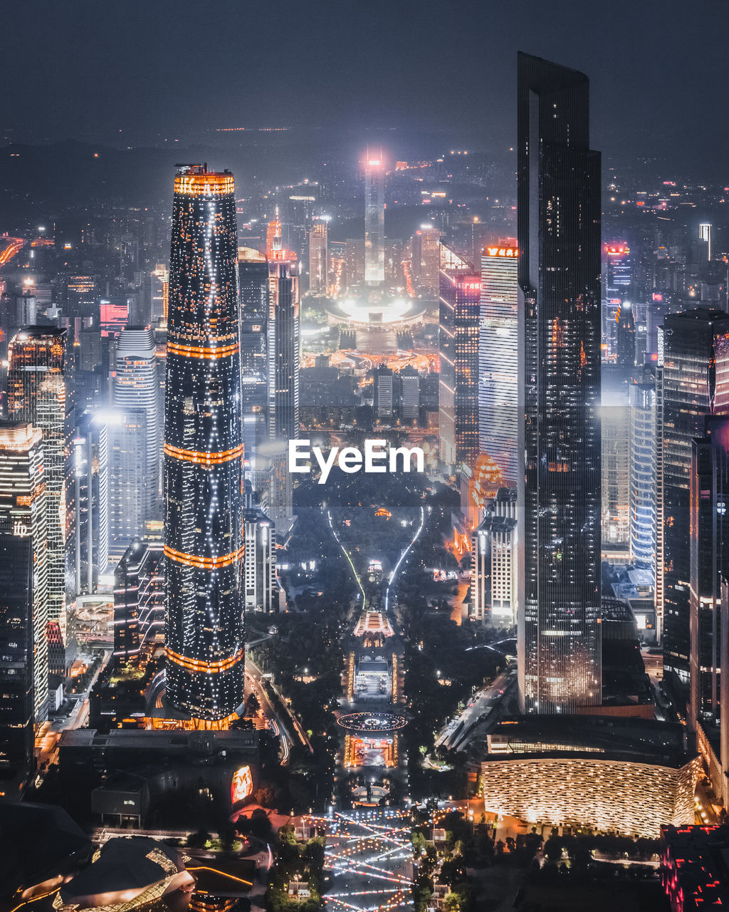 Aerial view of illuminated buildings in city at night