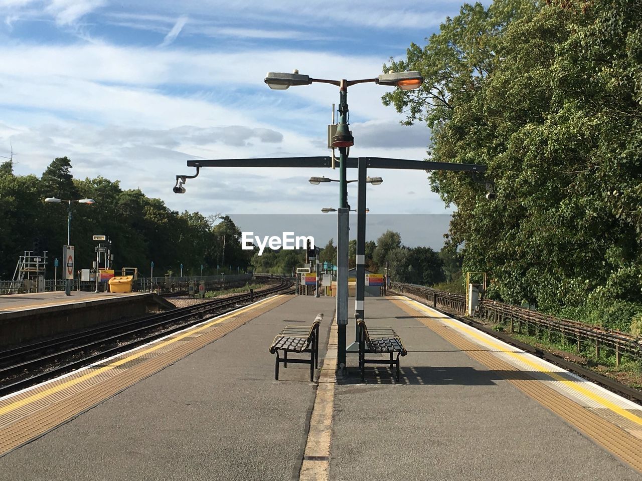 RAILROAD TRACKS AGAINST SKY AT STATION