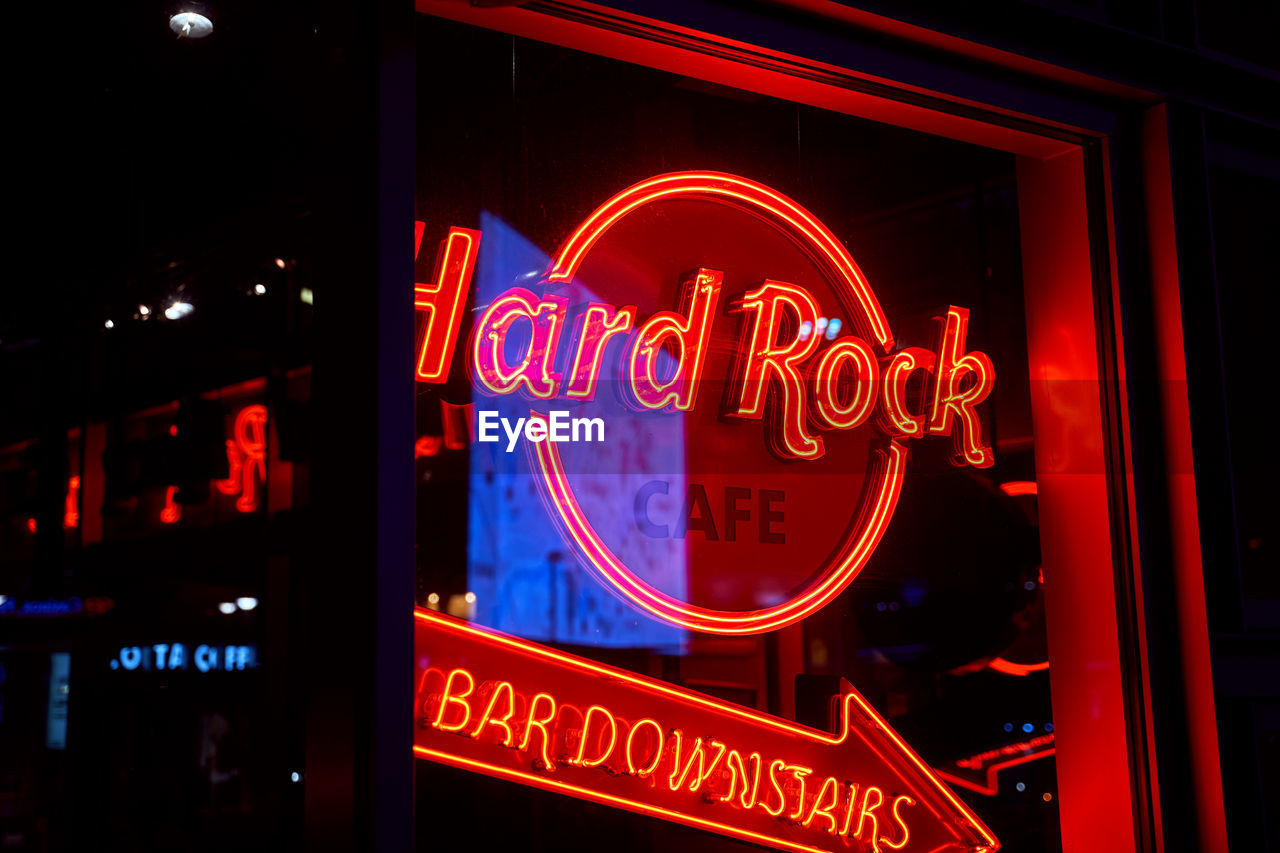 CLOSE-UP OF ILLUMINATED INFORMATION SIGN AT STORE