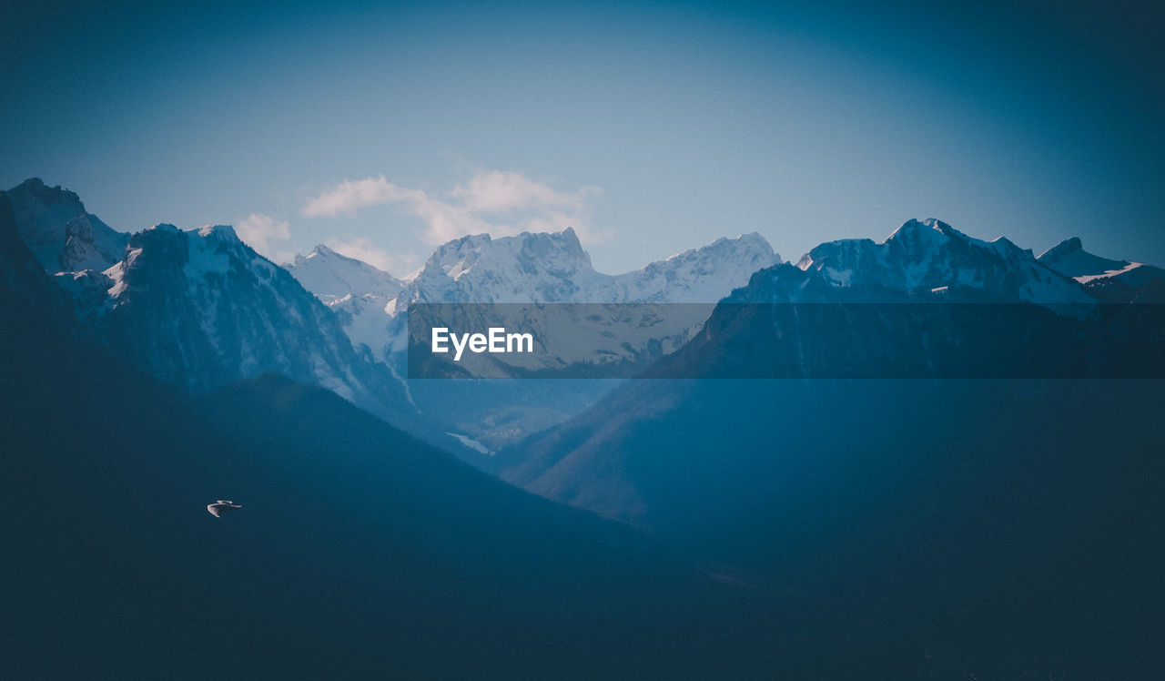 Scenic view of snowcapped mountains against sky