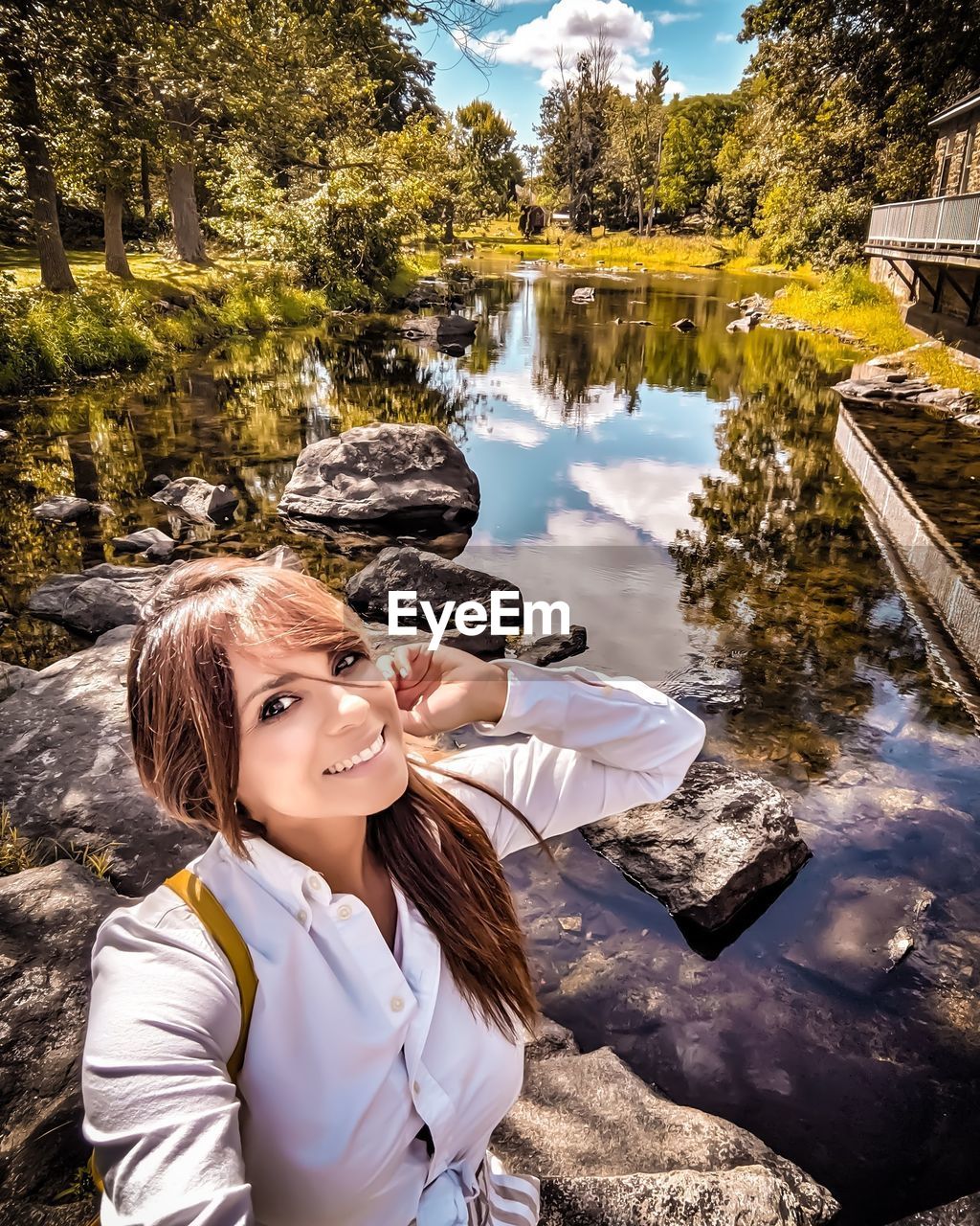 PORTRAIT OF WOMAN BY LAKE