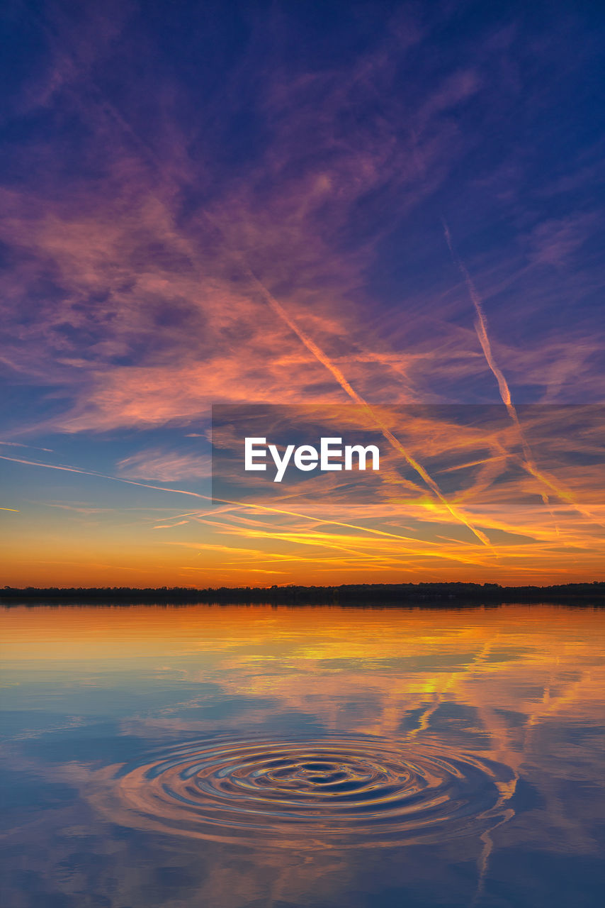 Scenic view of lake against romantic sky at sunset