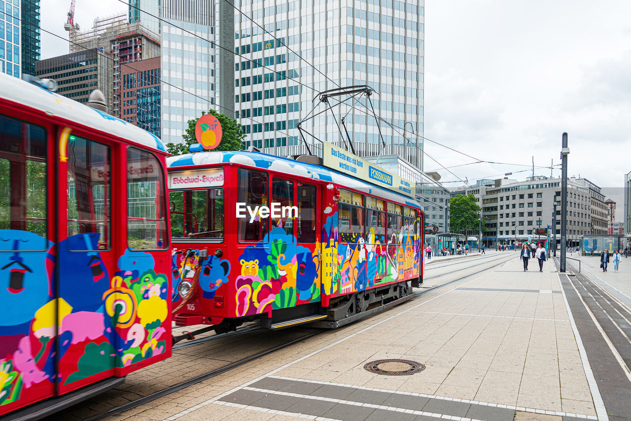 GRAFFITI ON CITY STREET BY BUILDINGS IN A TRAIN