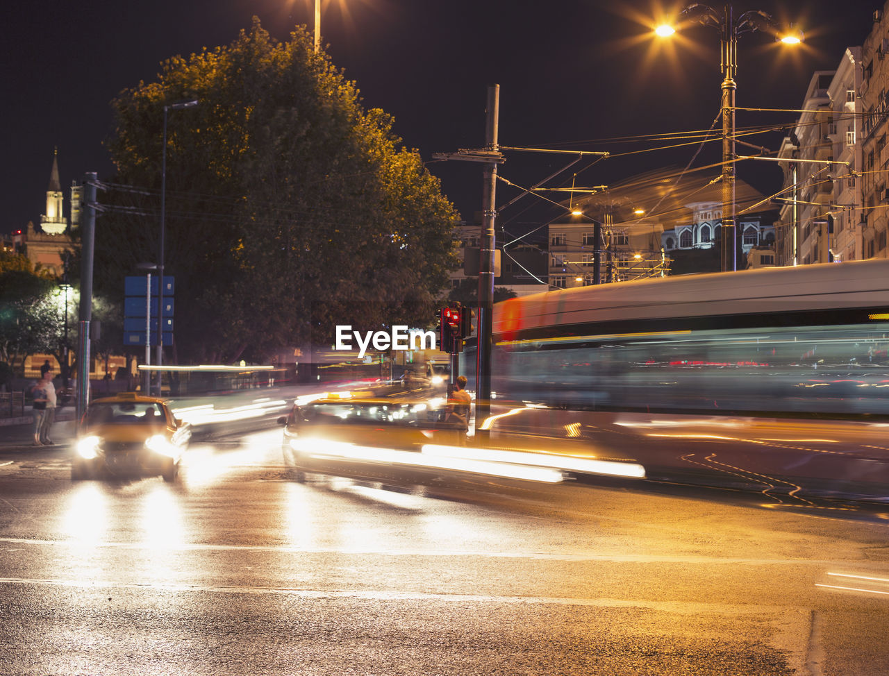 Blurred motion of cable car on road in city at night