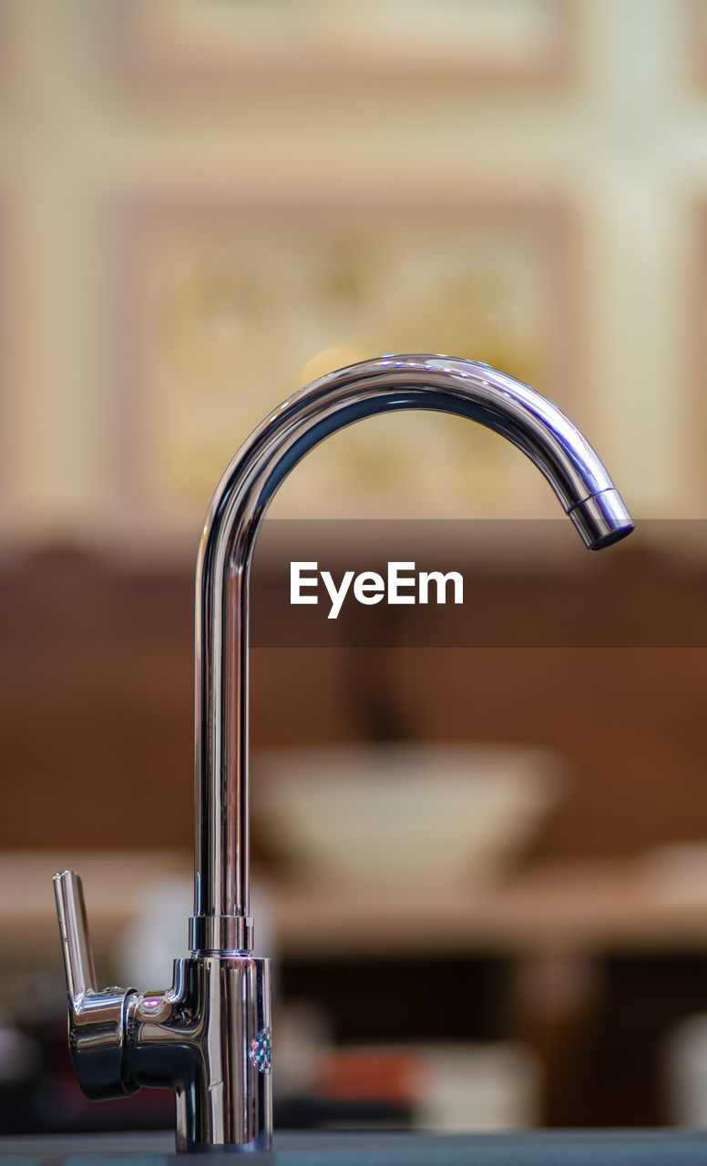 Close-up of faucet in bathroom at home