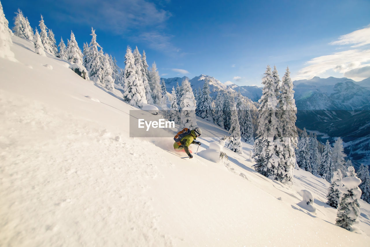 Man skiing on snowcapped mountain