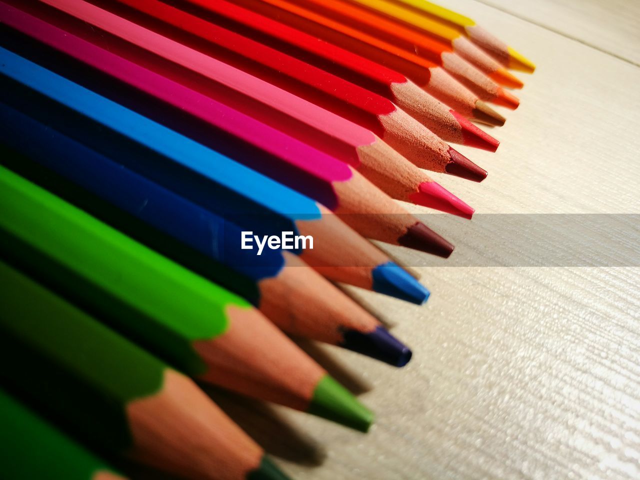 Close-up of colorful pencils arranged on table