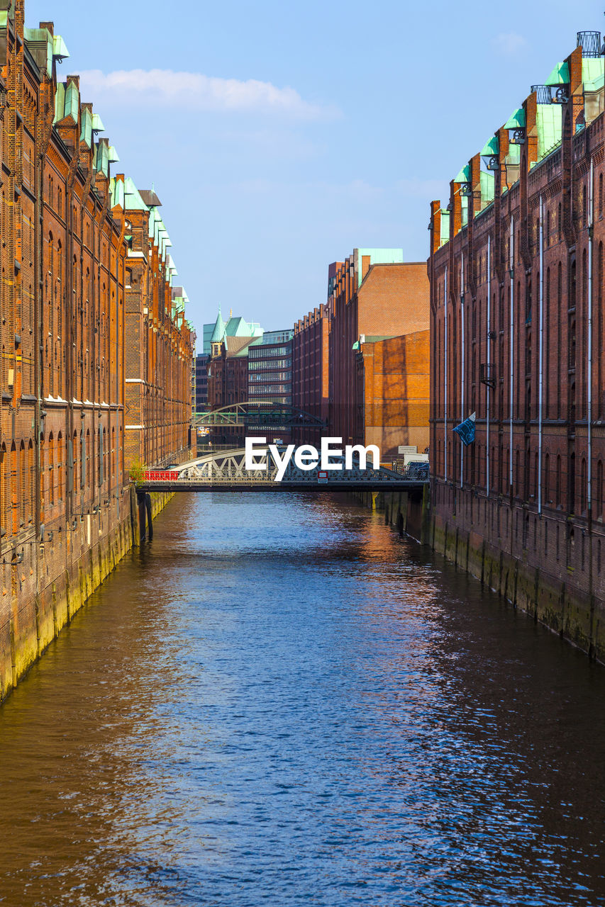 canal amidst buildings in background