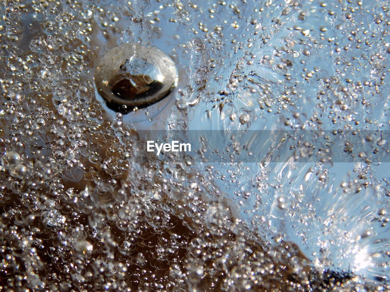 HIGH ANGLE VIEW OF WATER DROPS ON THE SURFACE