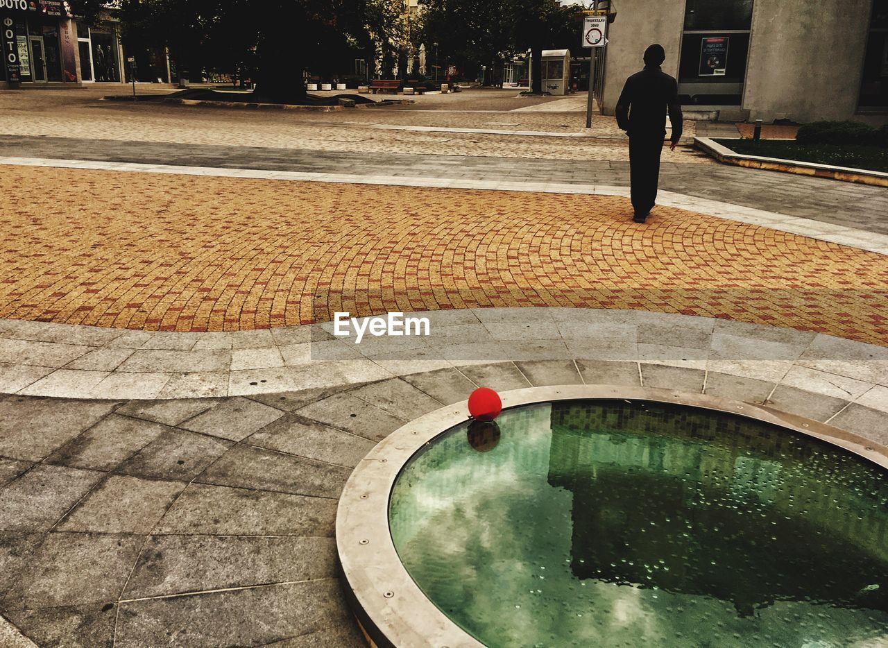 MAN IN SWIMMING POOL