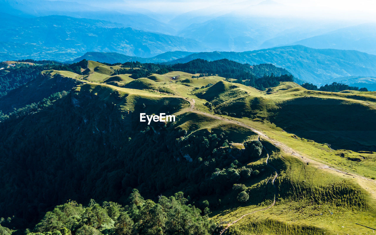 environment, landscape, mountain, scenics - nature, beauty in nature, mountain range, land, nature, sky, ridge, tranquility, travel, tranquil scene, plant, no people, non-urban scene, travel destinations, forest, aerial photography, tree, aerial view, valley, outdoors, wilderness, plateau, mountain pass, idyllic, cloud, pinaceae, tourism, social issues, rural scene, green, high angle view, mountain peak, coniferous tree, water, sunlight, pine tree, blue, day, environmental conservation, fog, cold temperature, summer, high up, snow