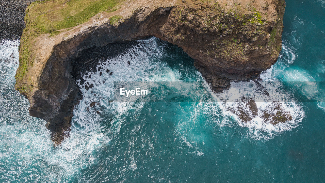 Aerial view of rock formation in sea