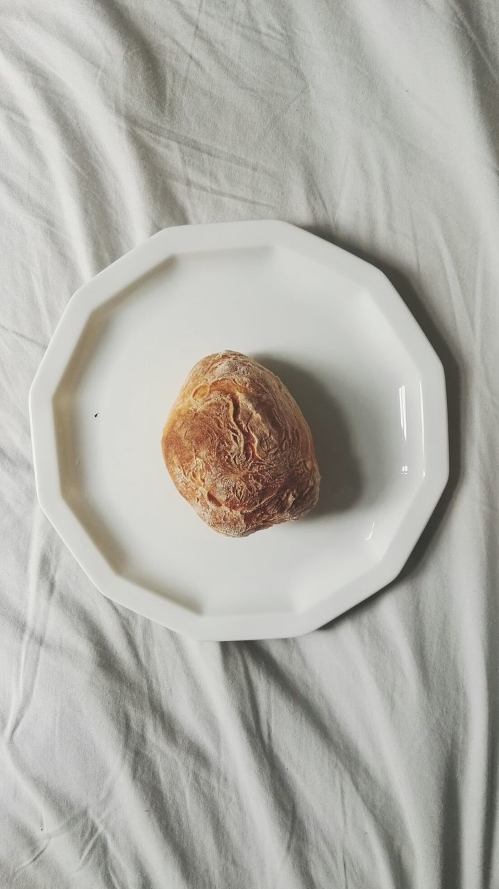 Directly above shot of bread in plate on bed