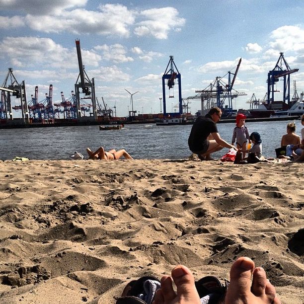 PEOPLE SITTING ON BOAT AT HARBOR