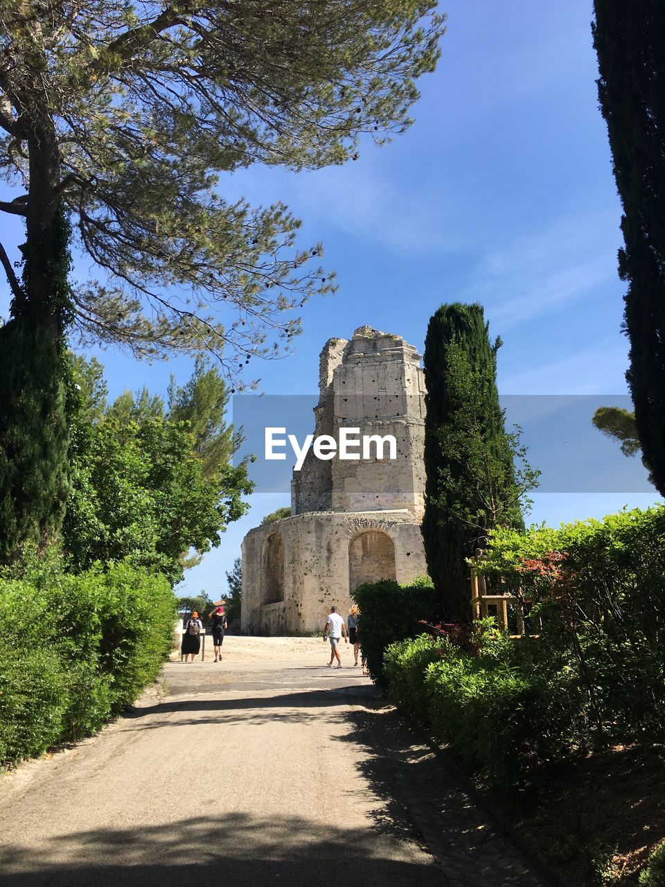 PEOPLE WALKING IN FRONT OF HISTORIC BUILDING