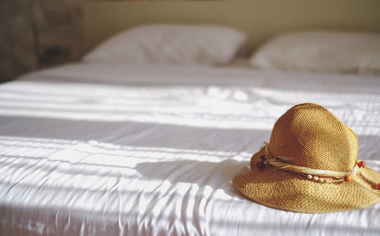 Hat on bed during sunny day