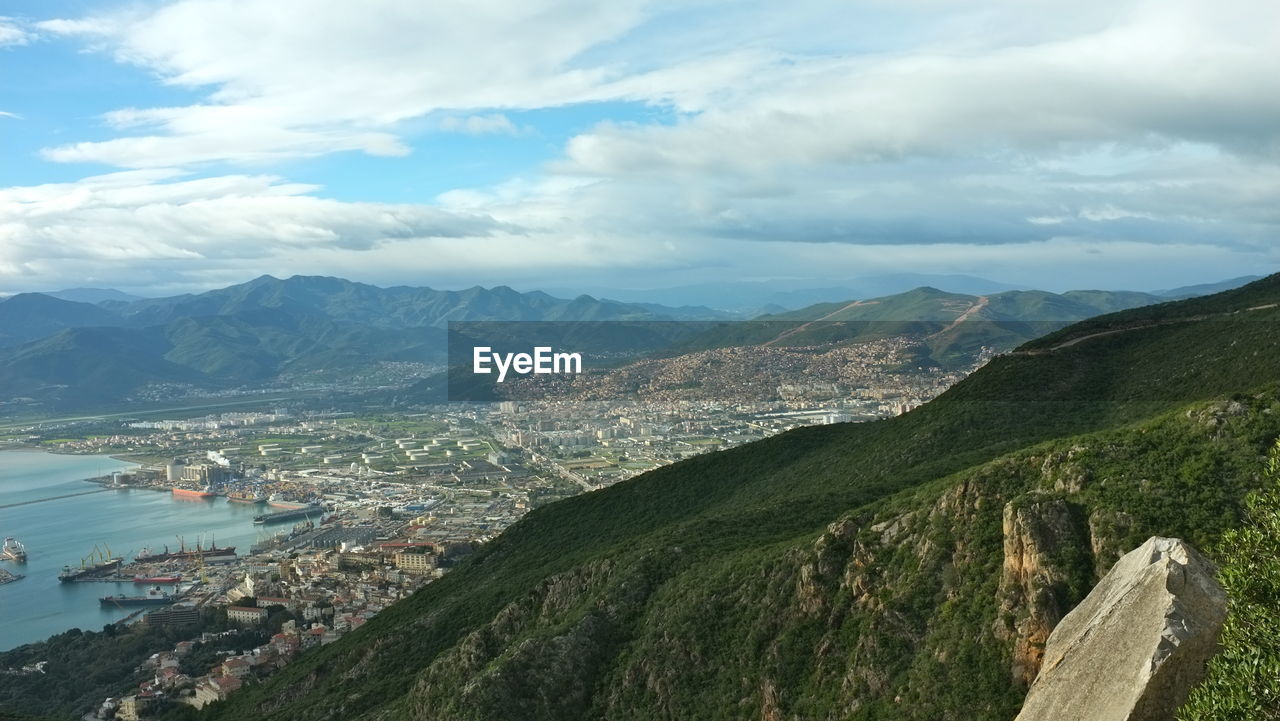 Scenic view of mountains against cloudy sky