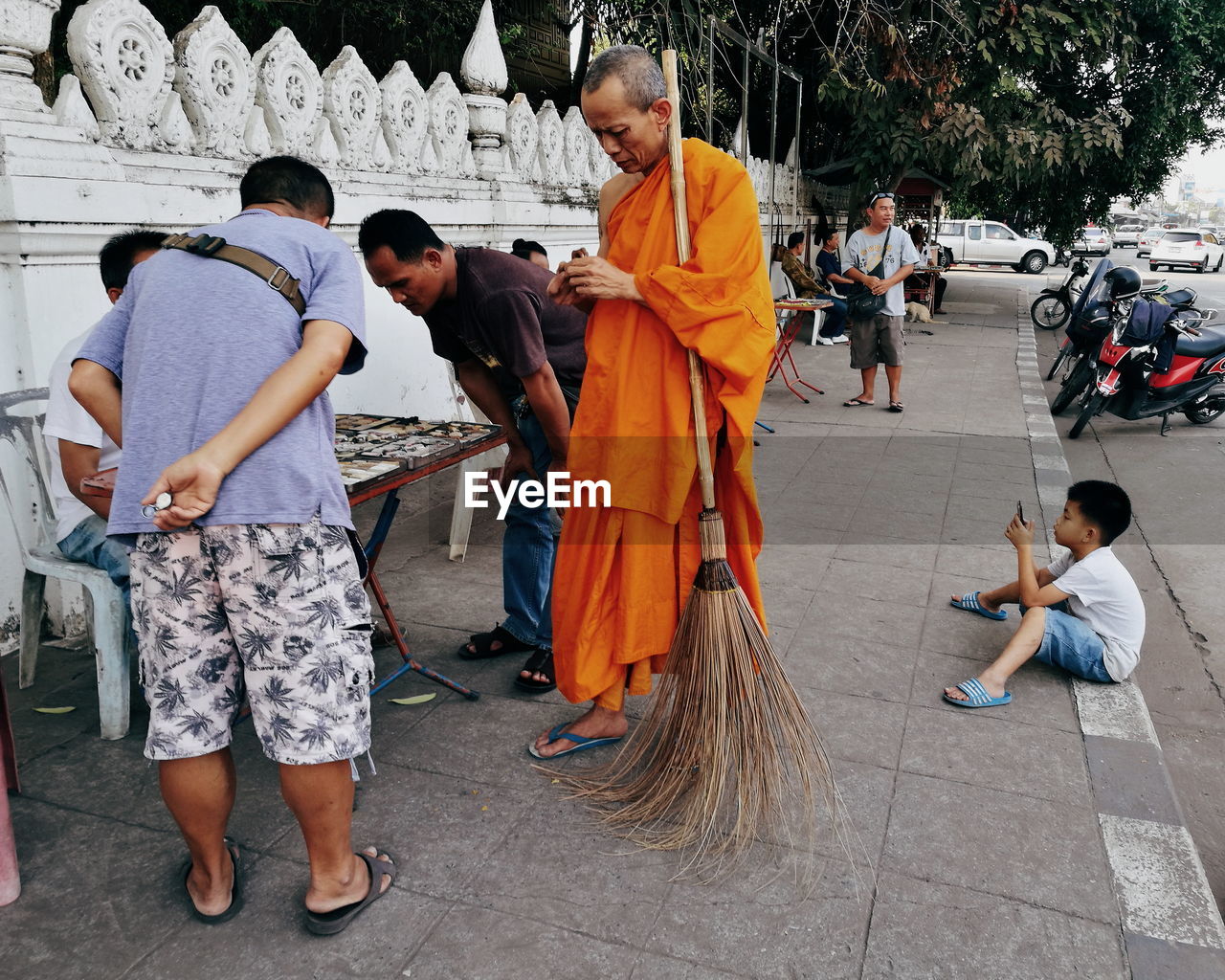 REAR VIEW OF PEOPLE STANDING AT TEMPLE